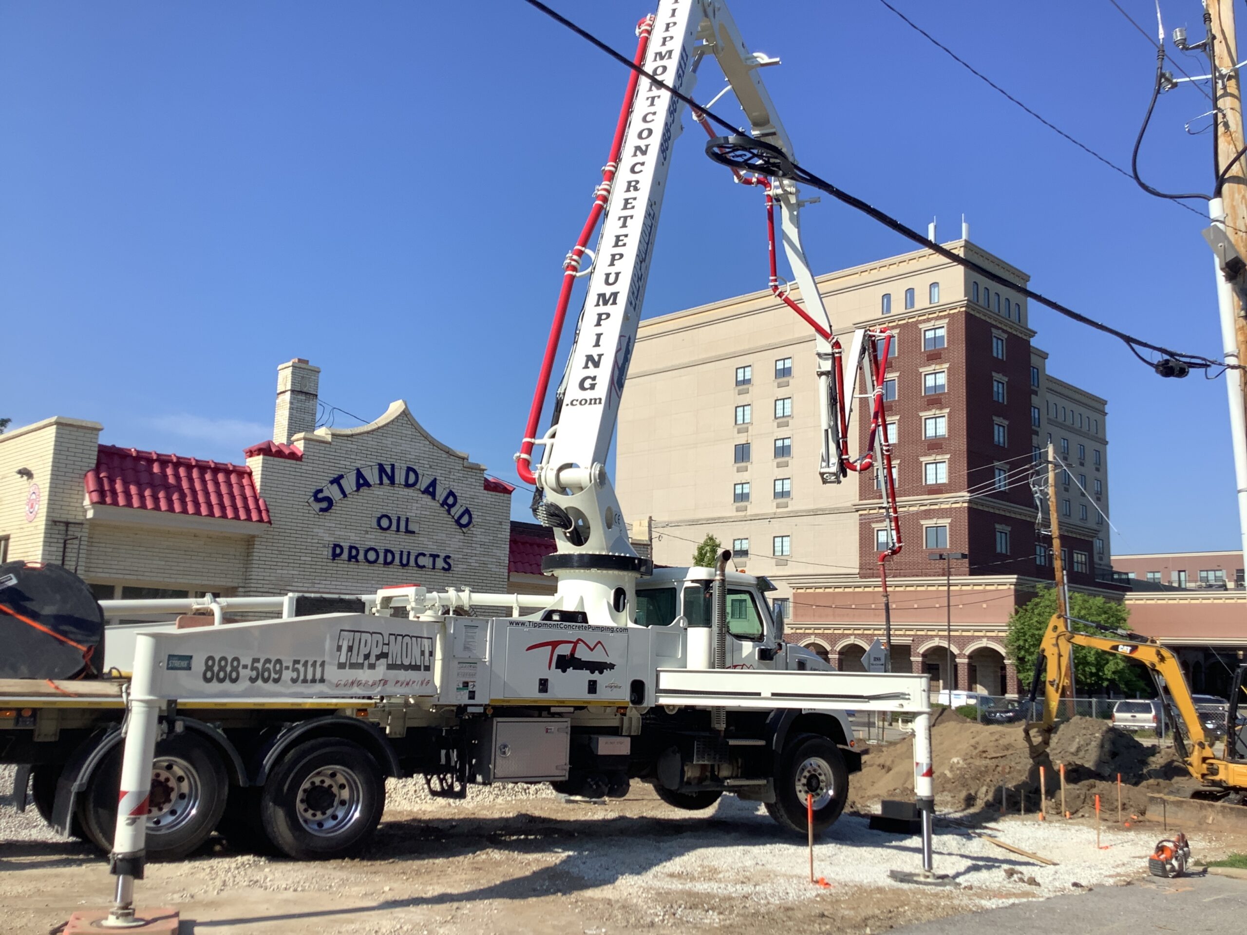 Tipp-Mont Concrete Pumping truck pumping concrete into the street of downtown West Lafayette, IN