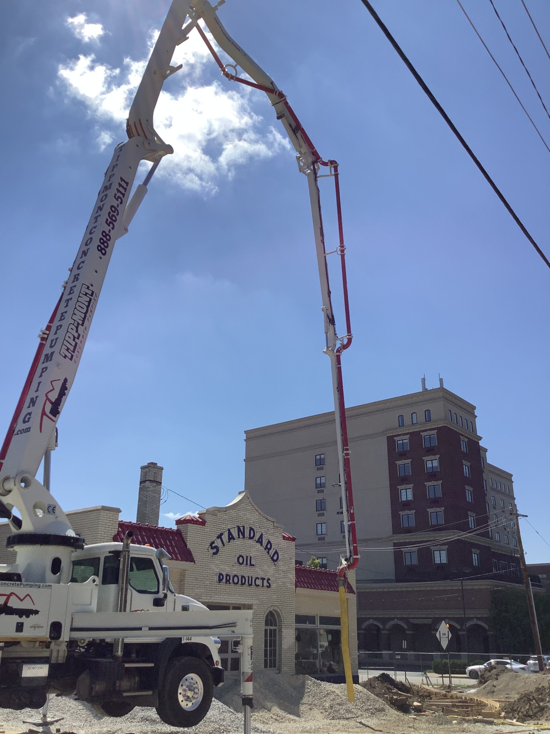 Tipp-Mont Concrete Pumping truck pumping concrete into the street of downtown West Lafayette, IN