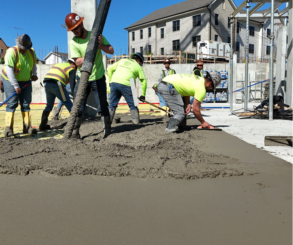 The Tipp-Mont Concrete Pumping team in West Lafayette, IN holding a large concrete pipe